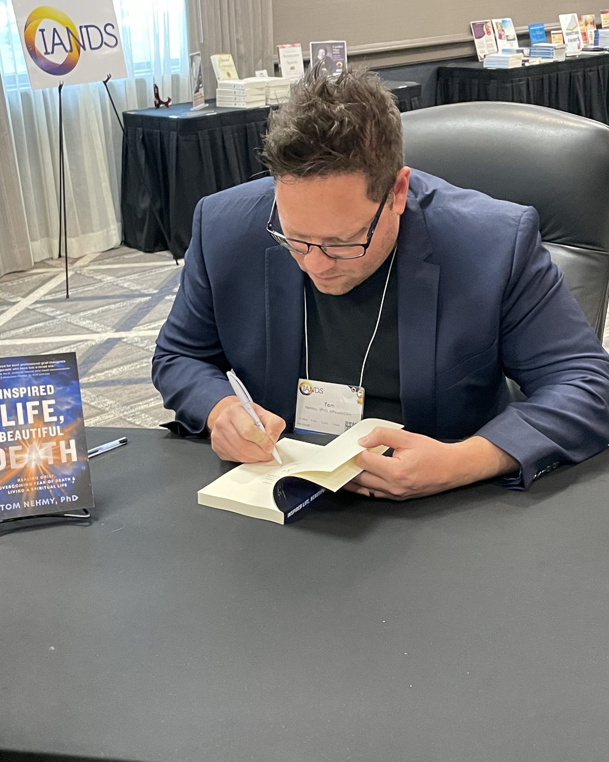 Tom Nehmy signing Inspired Life, Beautiful Death at the IANDS 2025 conference book signing, Chicago